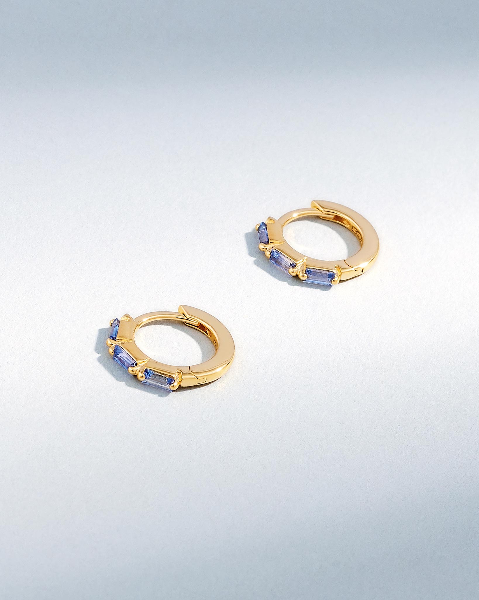 Suzanne Kalan Bold Triple Light Blue Sapphire Huggies in 18K yellow gold