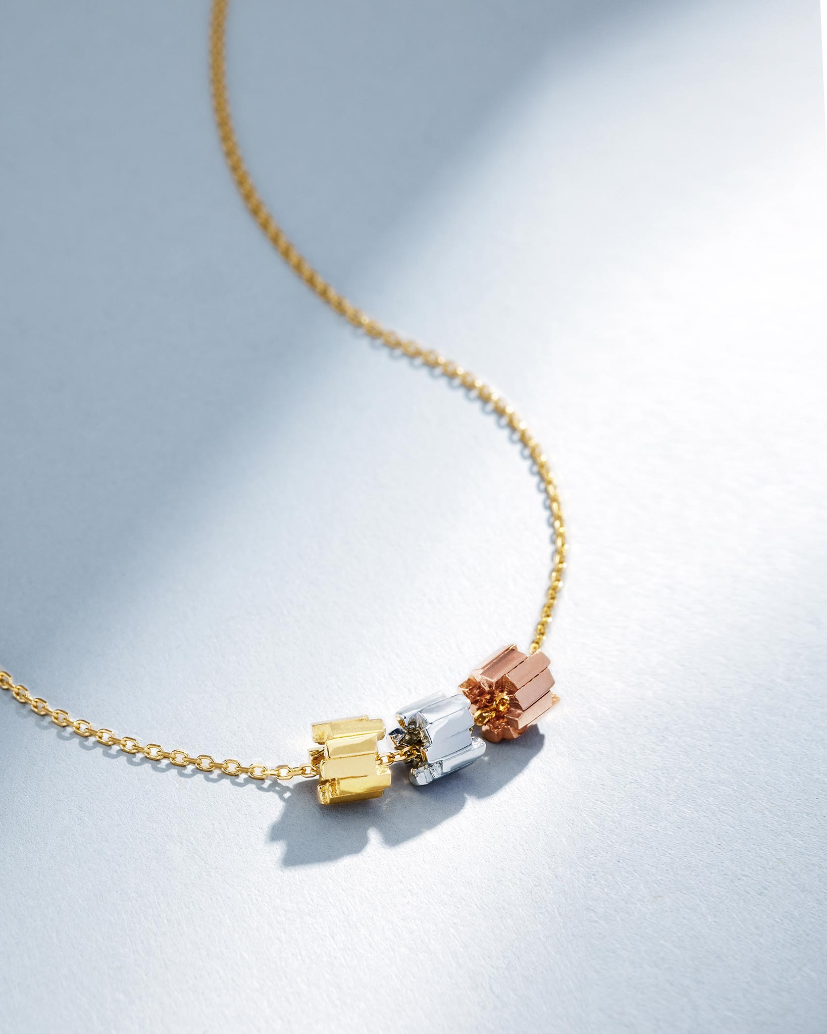 Suzanne Kalan Infinite Triple Golden Mini Tri-Color Rondelle Pendant with an 18k yellow gold chain