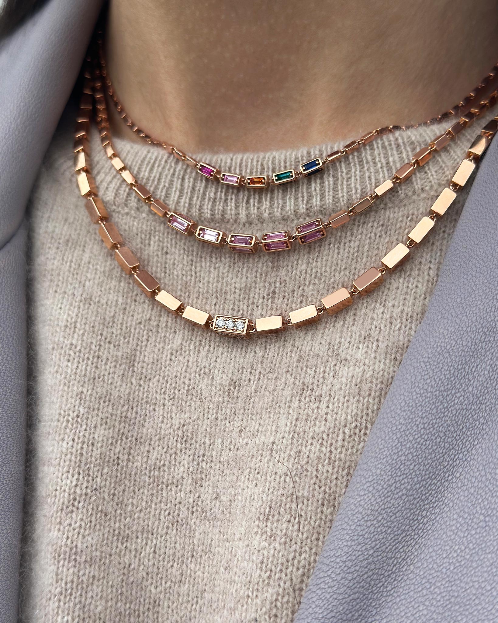 Suzanne Kalan model styling three Block-Chain necklaces in 18k rose gold