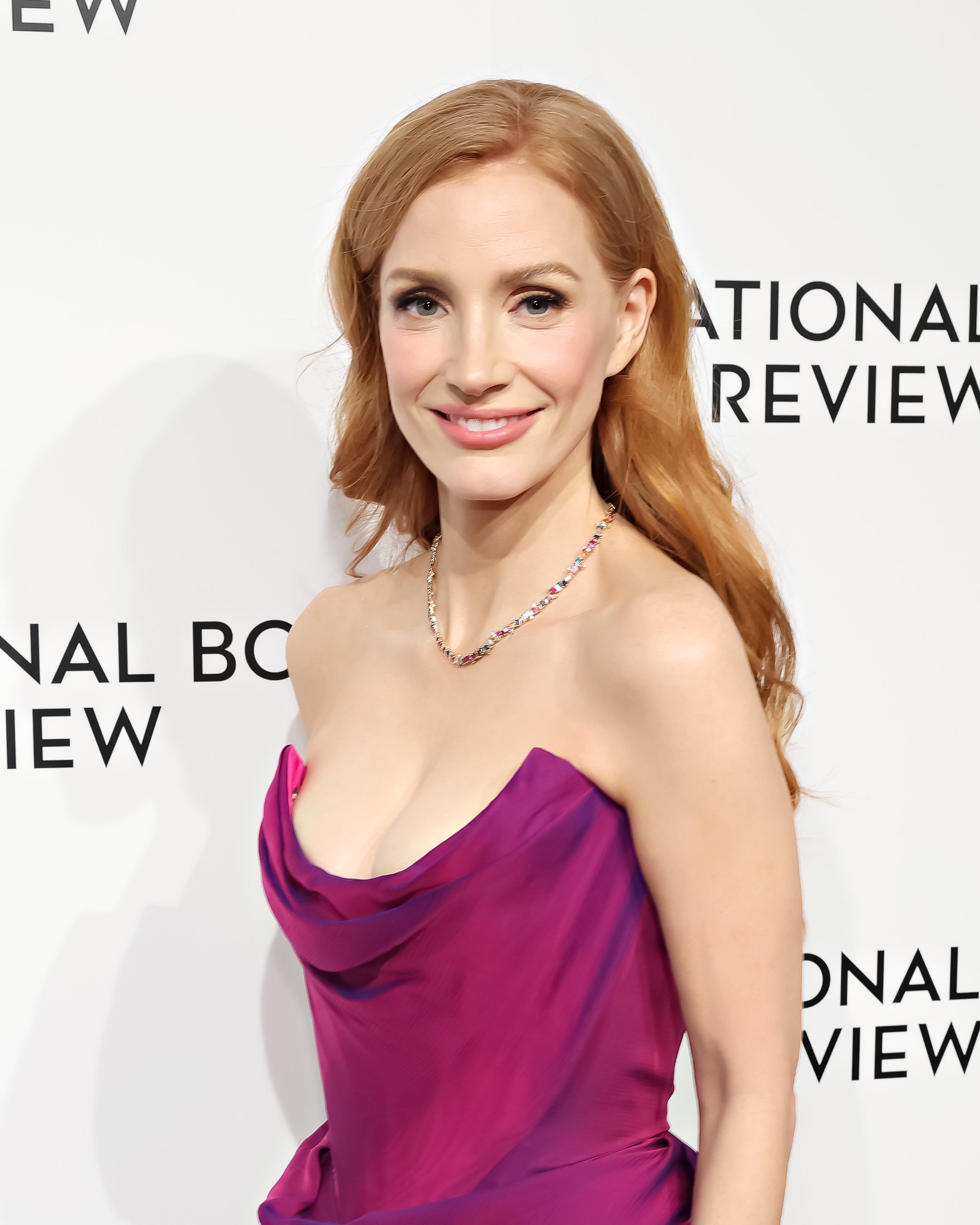 Jessica Chastain styling our Bold Burst Rainbow Sapphire Tennis Necklace in 18k yellow gold